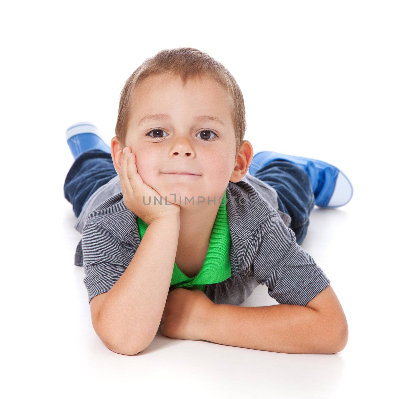 Full length shot of a cute little boy lying on the floor. All isolated on white background.