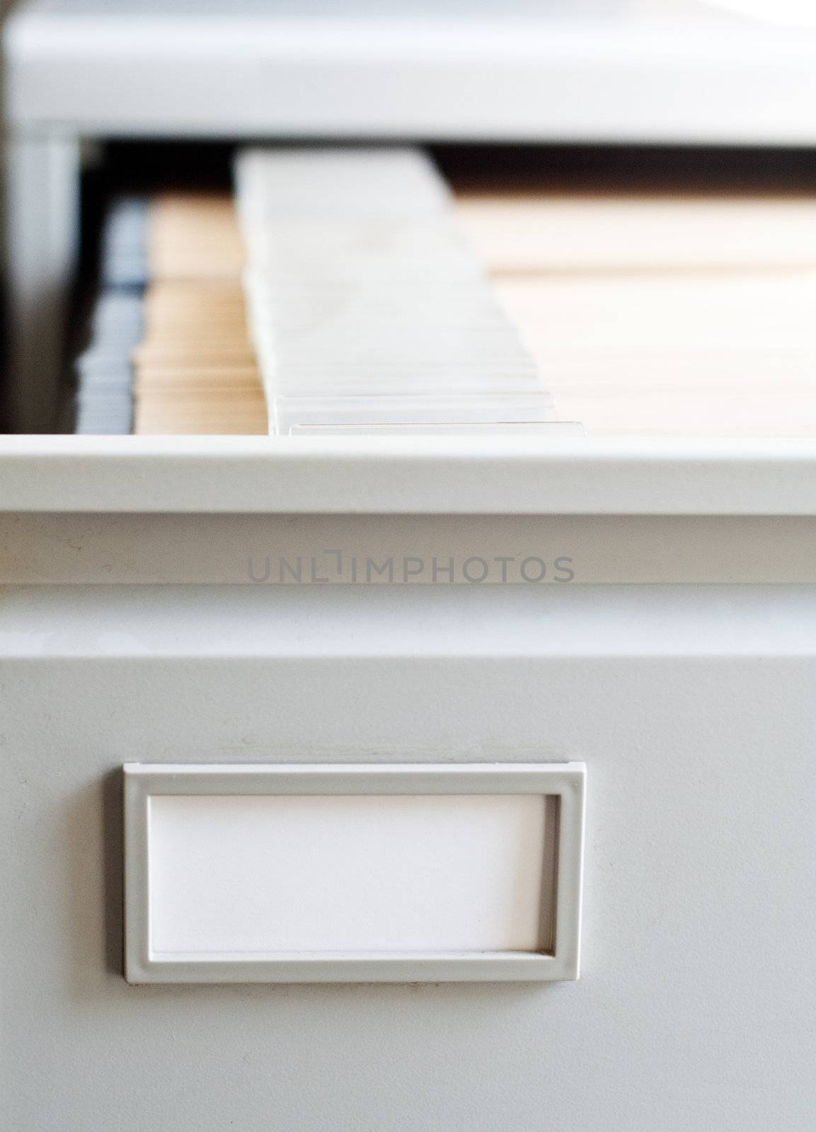 Opened drawer of a file cabinet by kaarsten