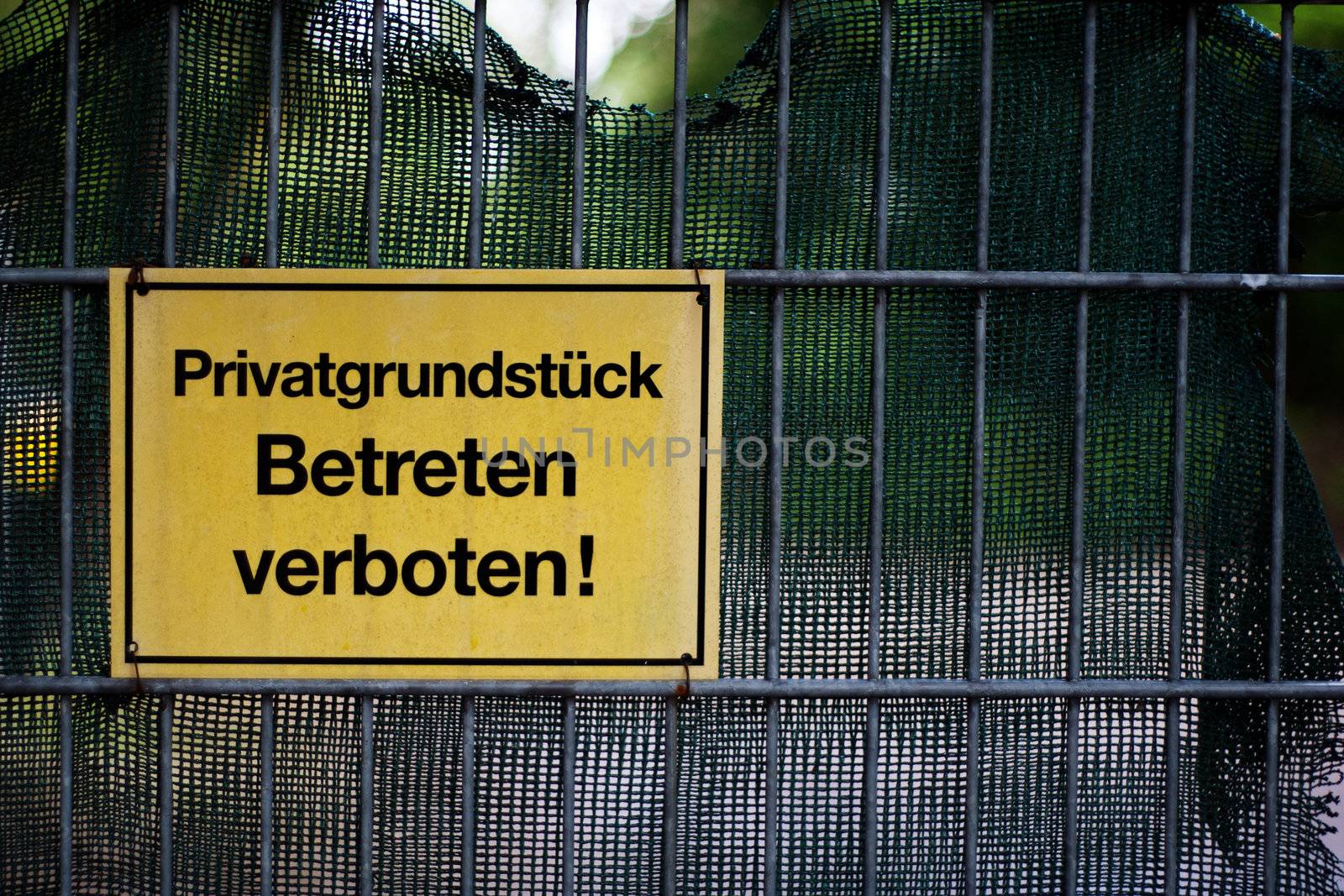 Fence with sign showing the german term for private property - no trespassing.