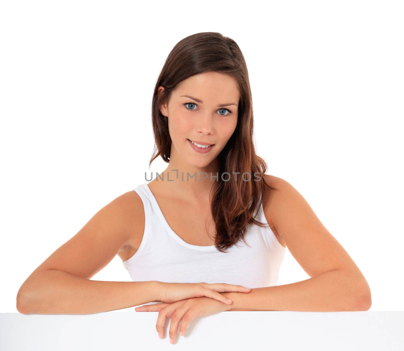 Attractive young woman standing behind blank white sign. All on white background.
