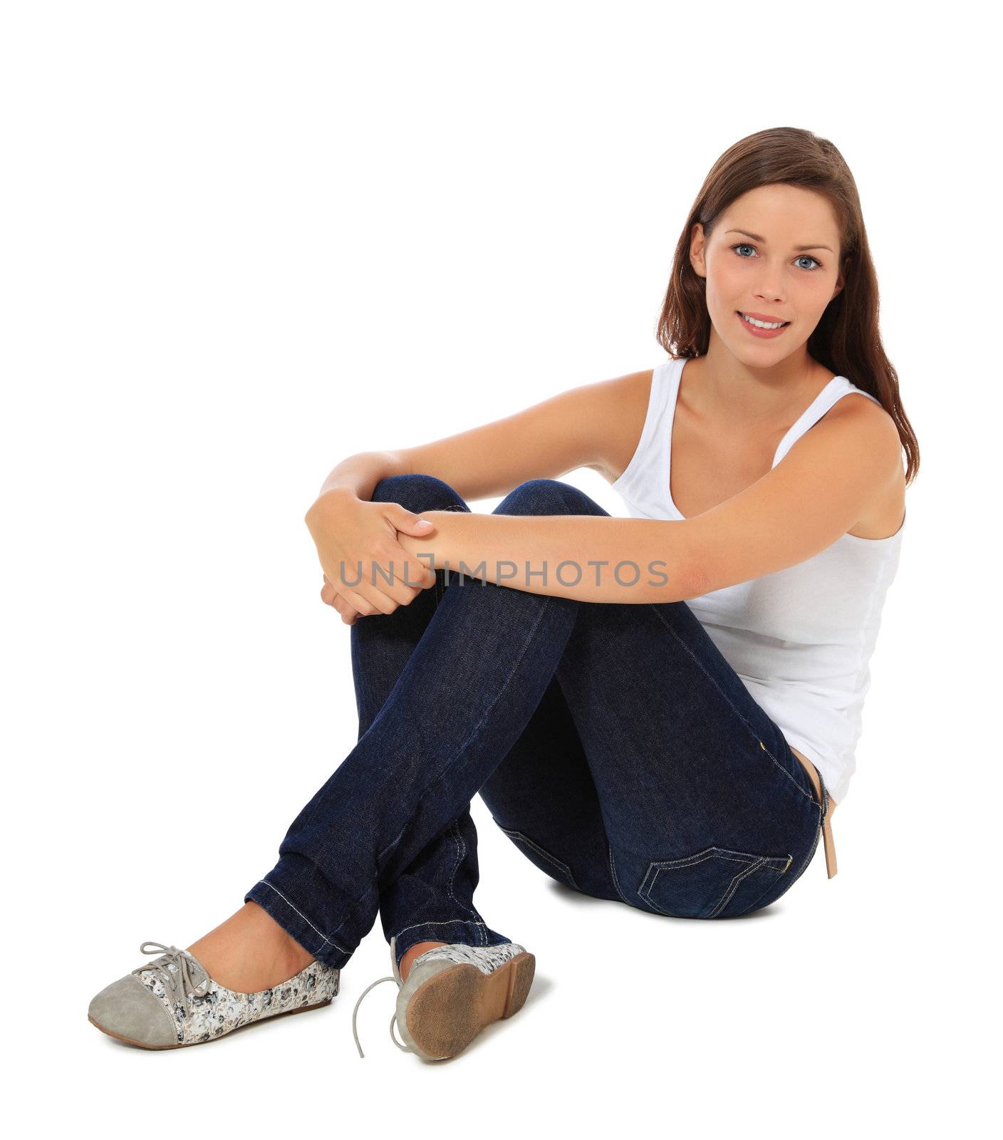 Attractive young woman sitting on the floor. All on white background.