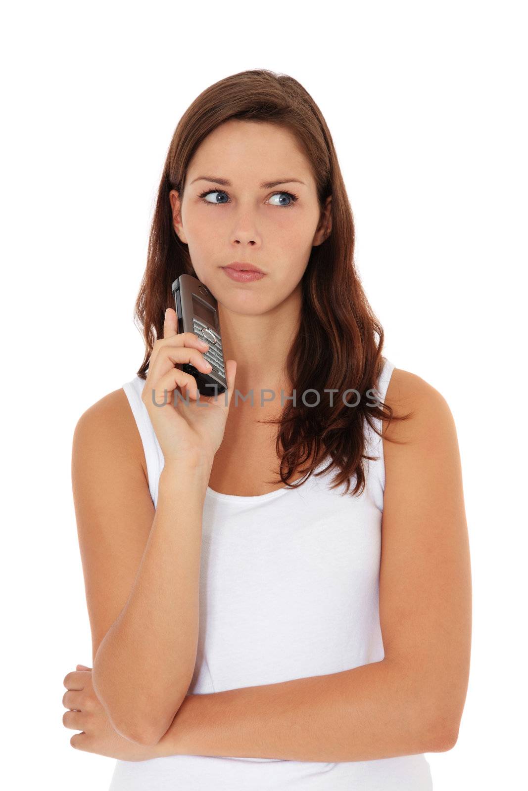 Attractive young woman awaits a phone call. All on white background.