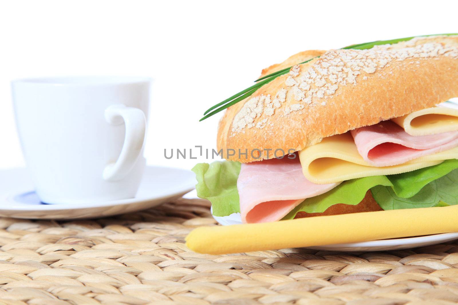 Fresh made roll with cheese and boiled ham. All on white background.