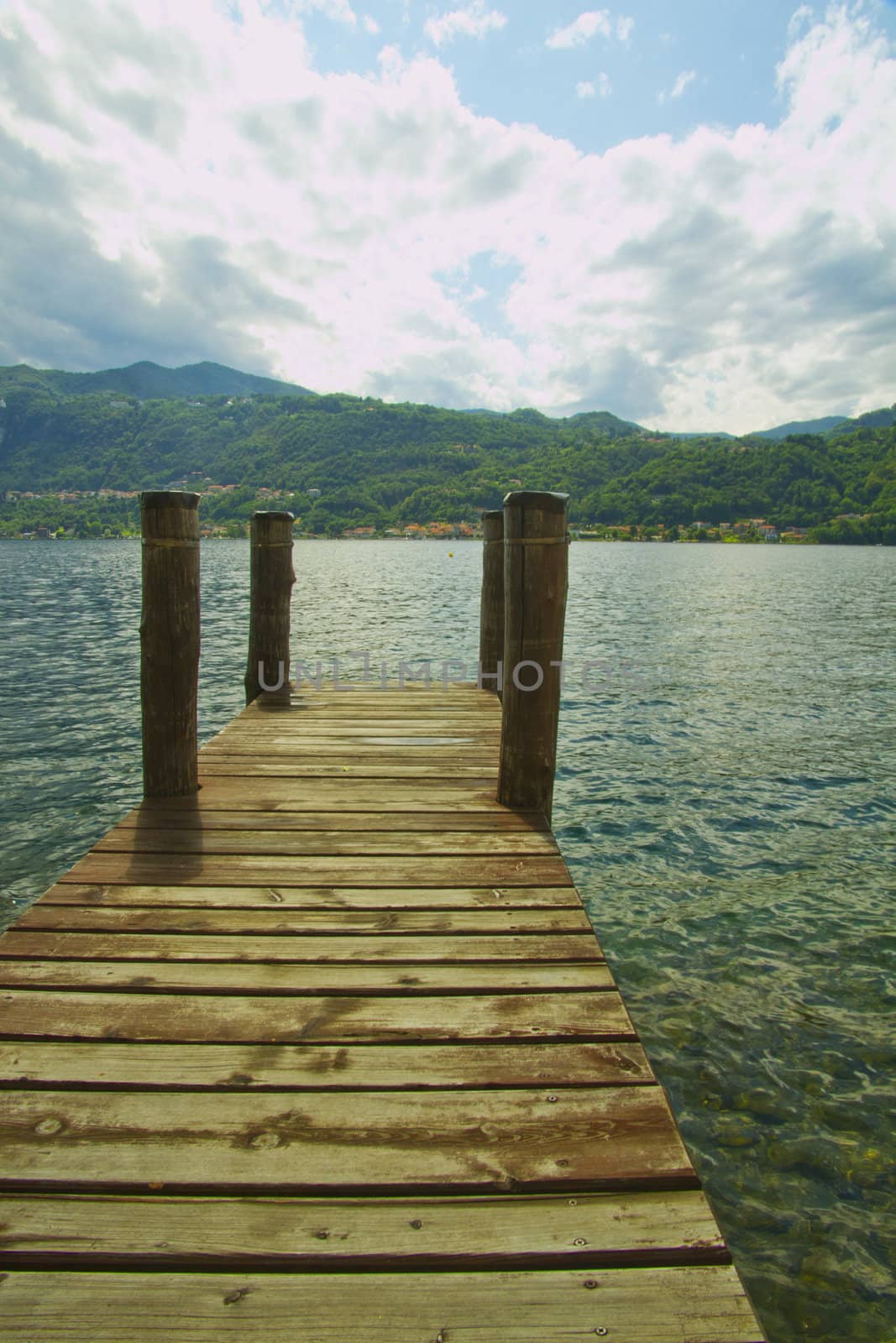 A pier pointing towards a blue lake