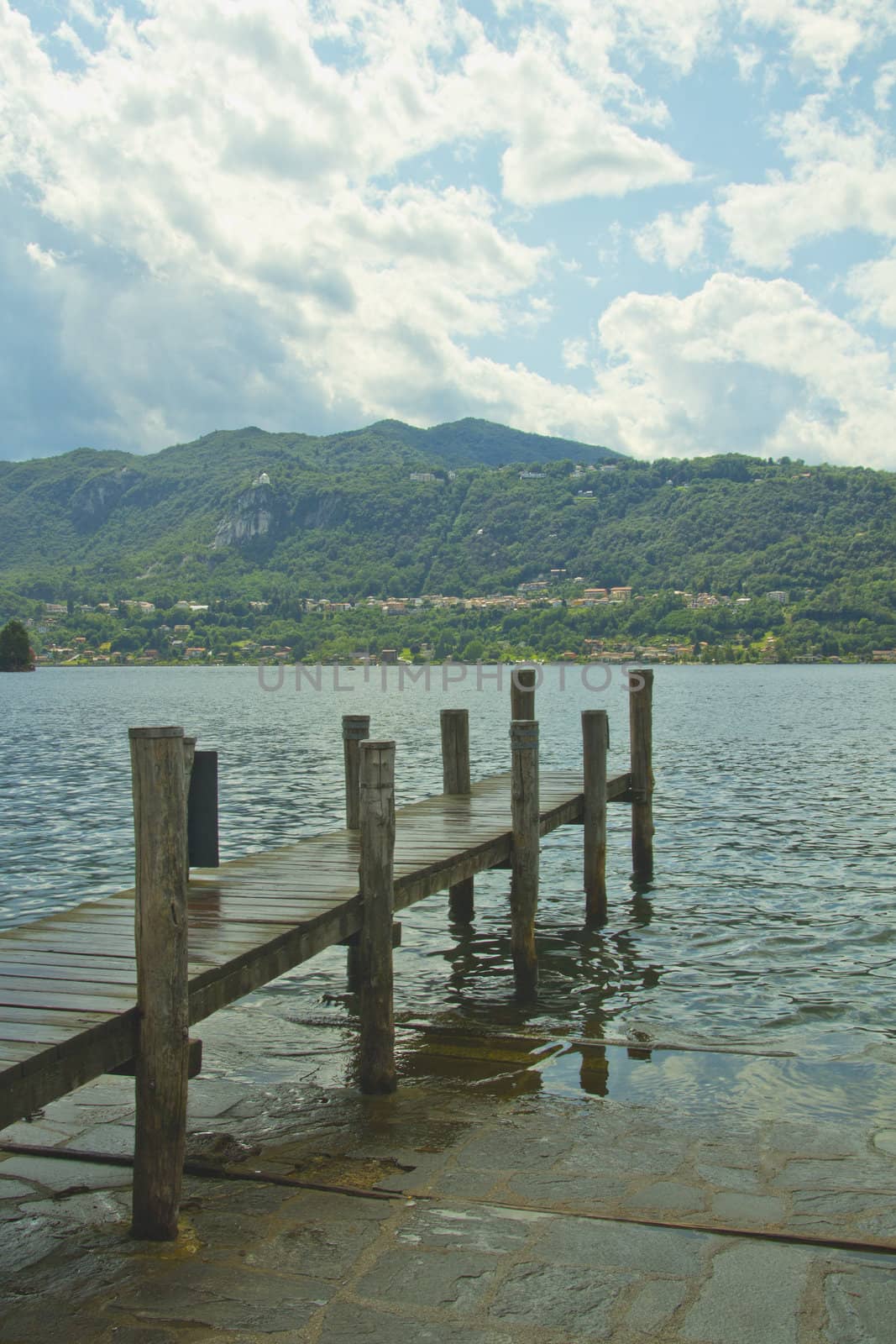 A pier pointing towards a blue lake