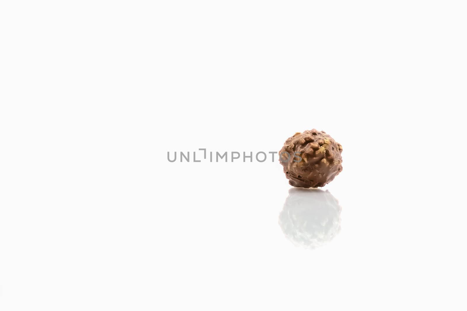 Chocolate ball isolate on white background with reflection