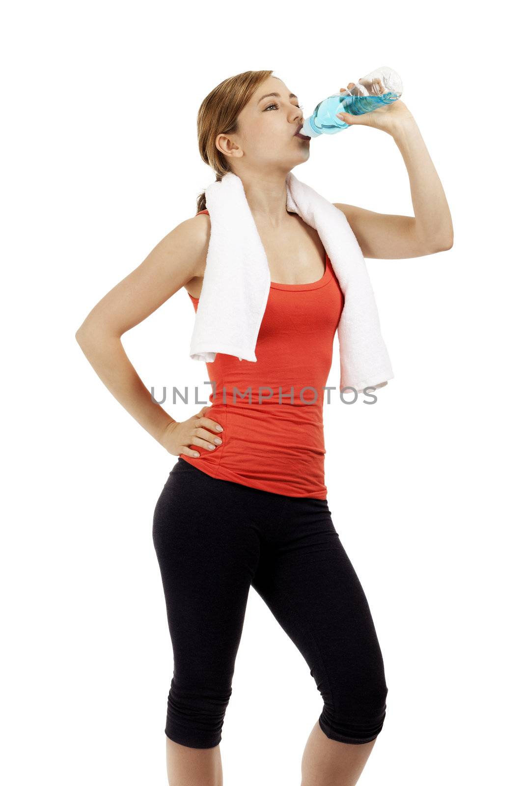 cute young fitness woman drinking water on white background