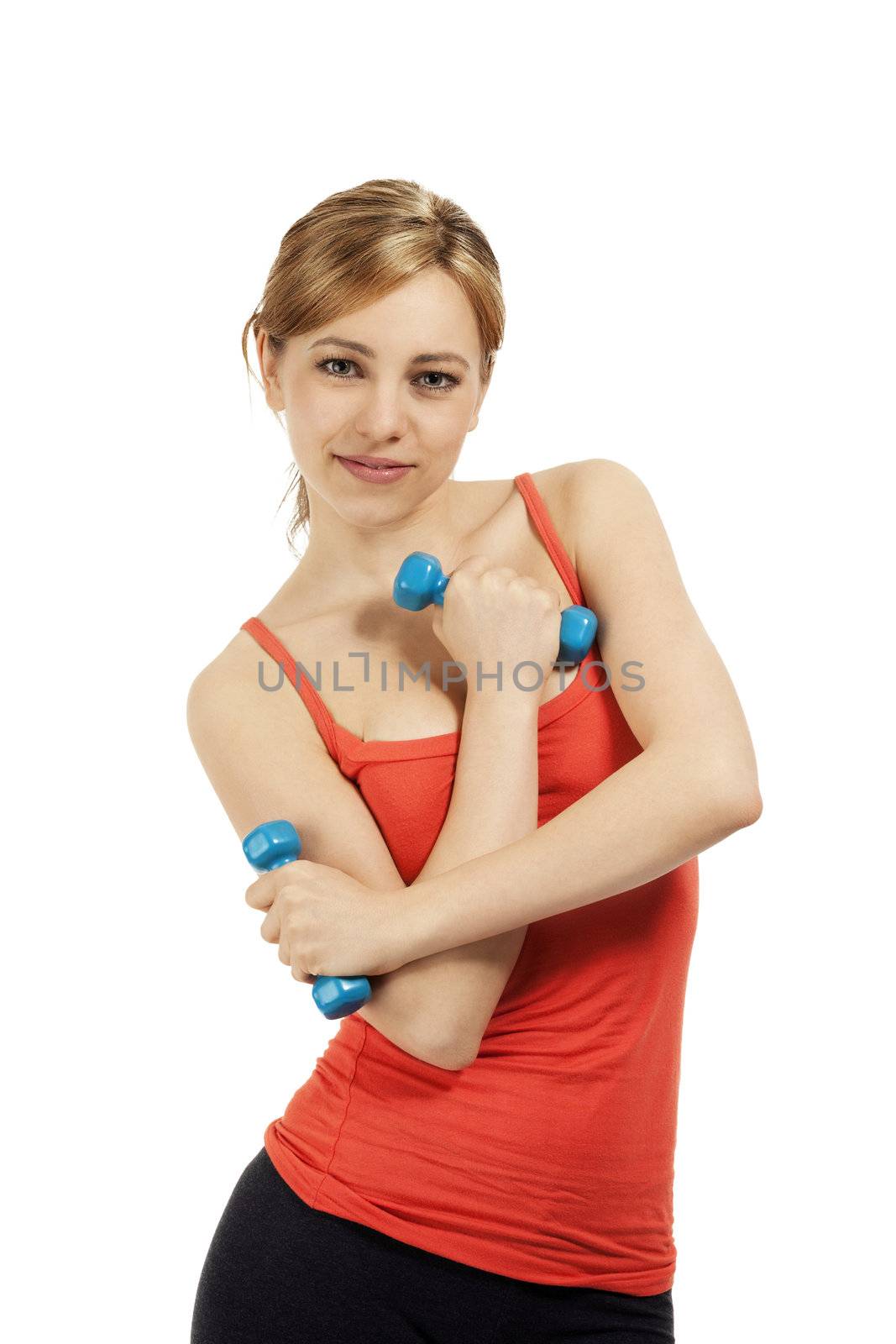 smiling young fitness woman holding blue dumbbells on white background