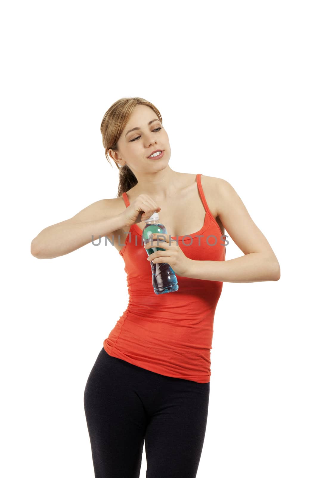 young cute fitness woman opening a bottle of water looking to side on white background
