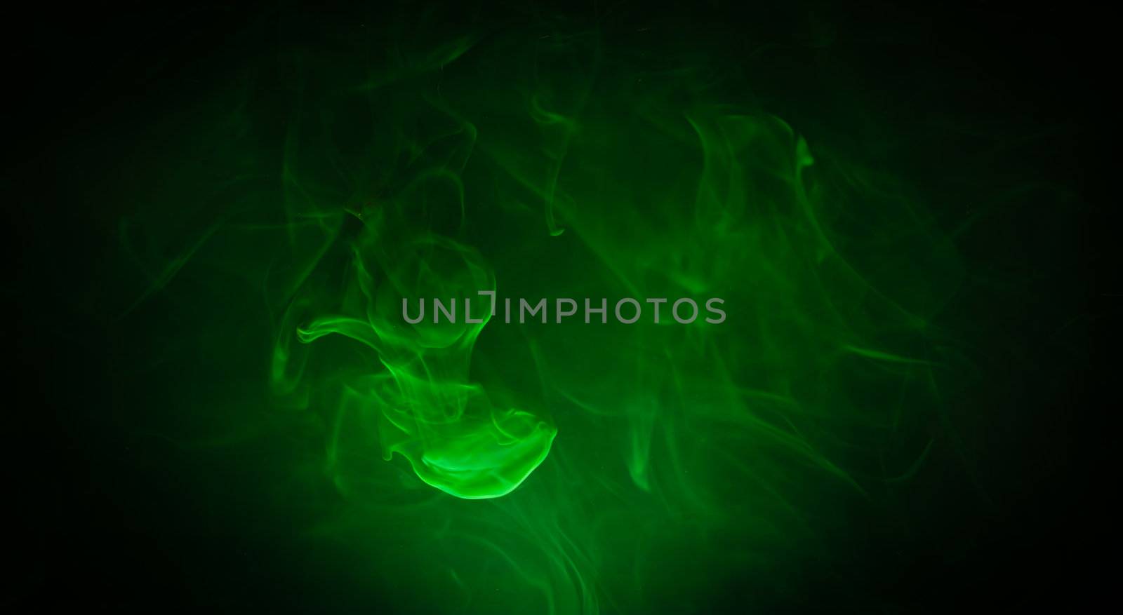 Green smoke in the dark on black background