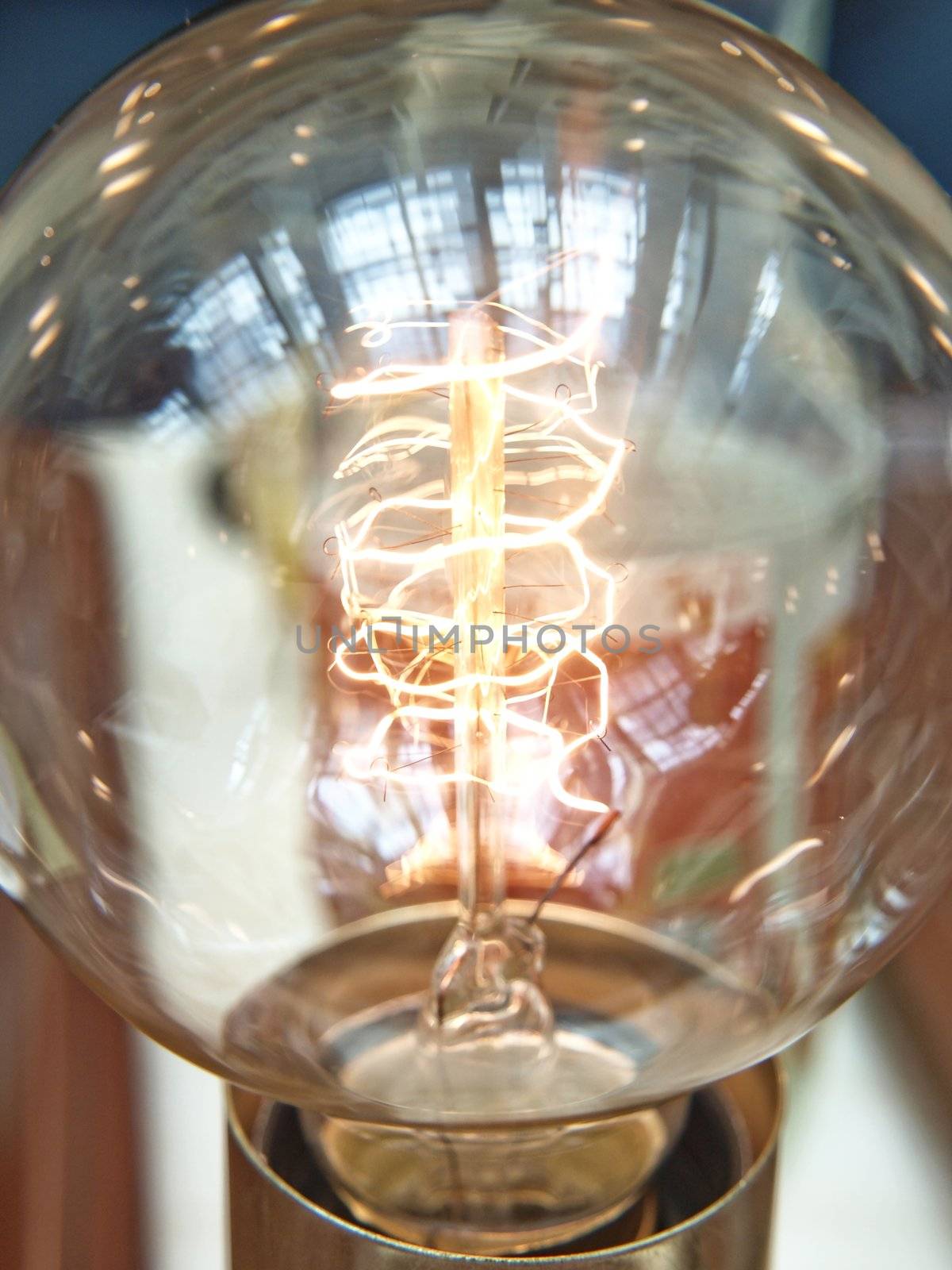 Closeup of a lit light bulb, isolated