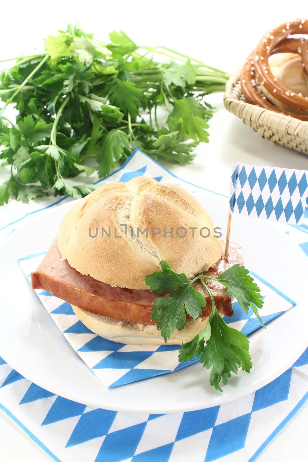 Roll with beef and pork loaf, mustard, parsley on a light background