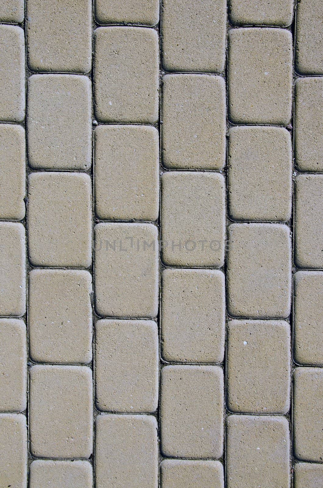 Path background fragment. Path made of small grey bricks.