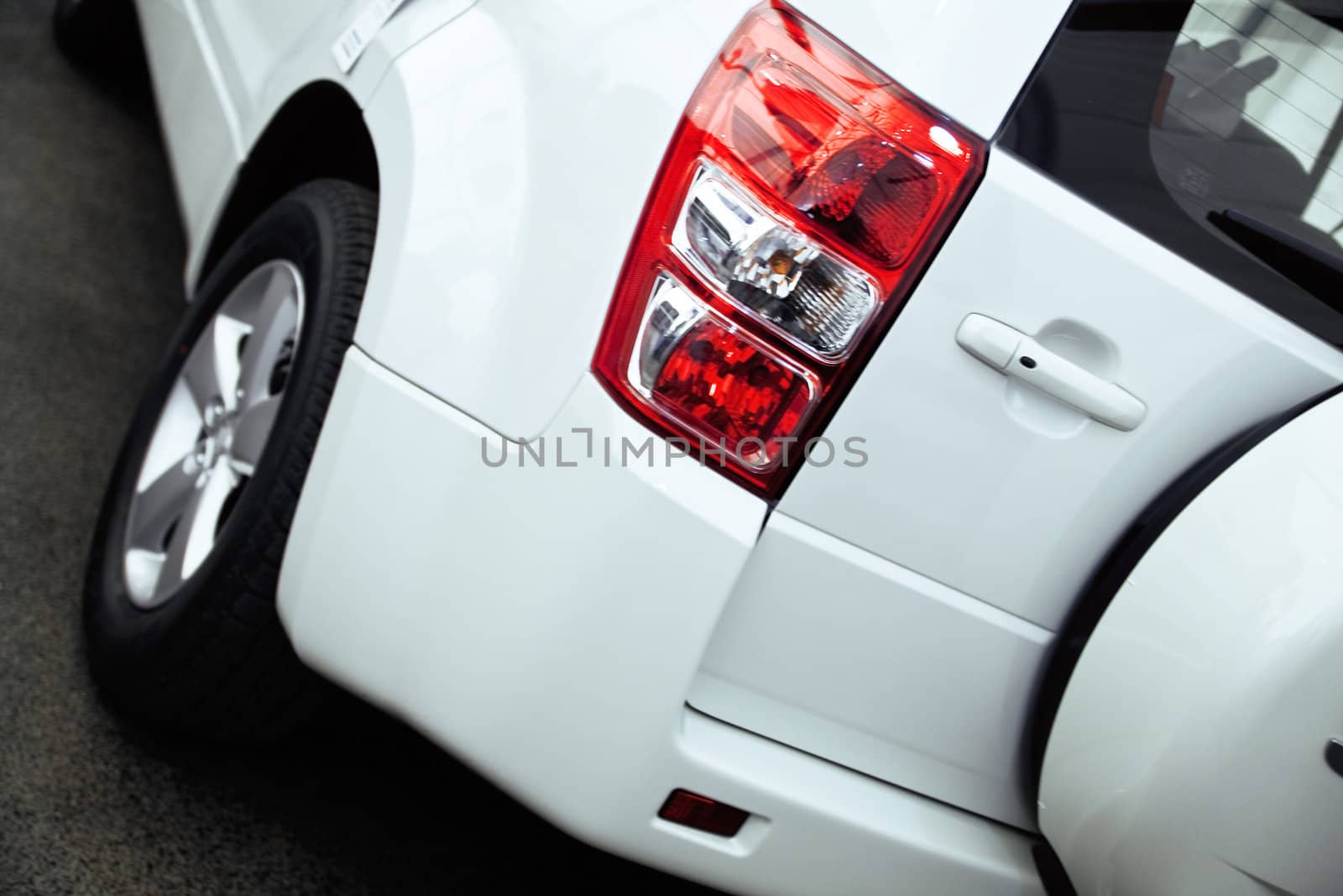 red rear lights of modern passenger car by Serp