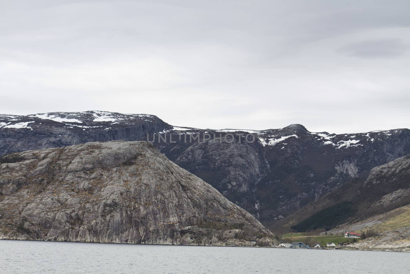 landscape in norway - coastline in fjord and dark sky