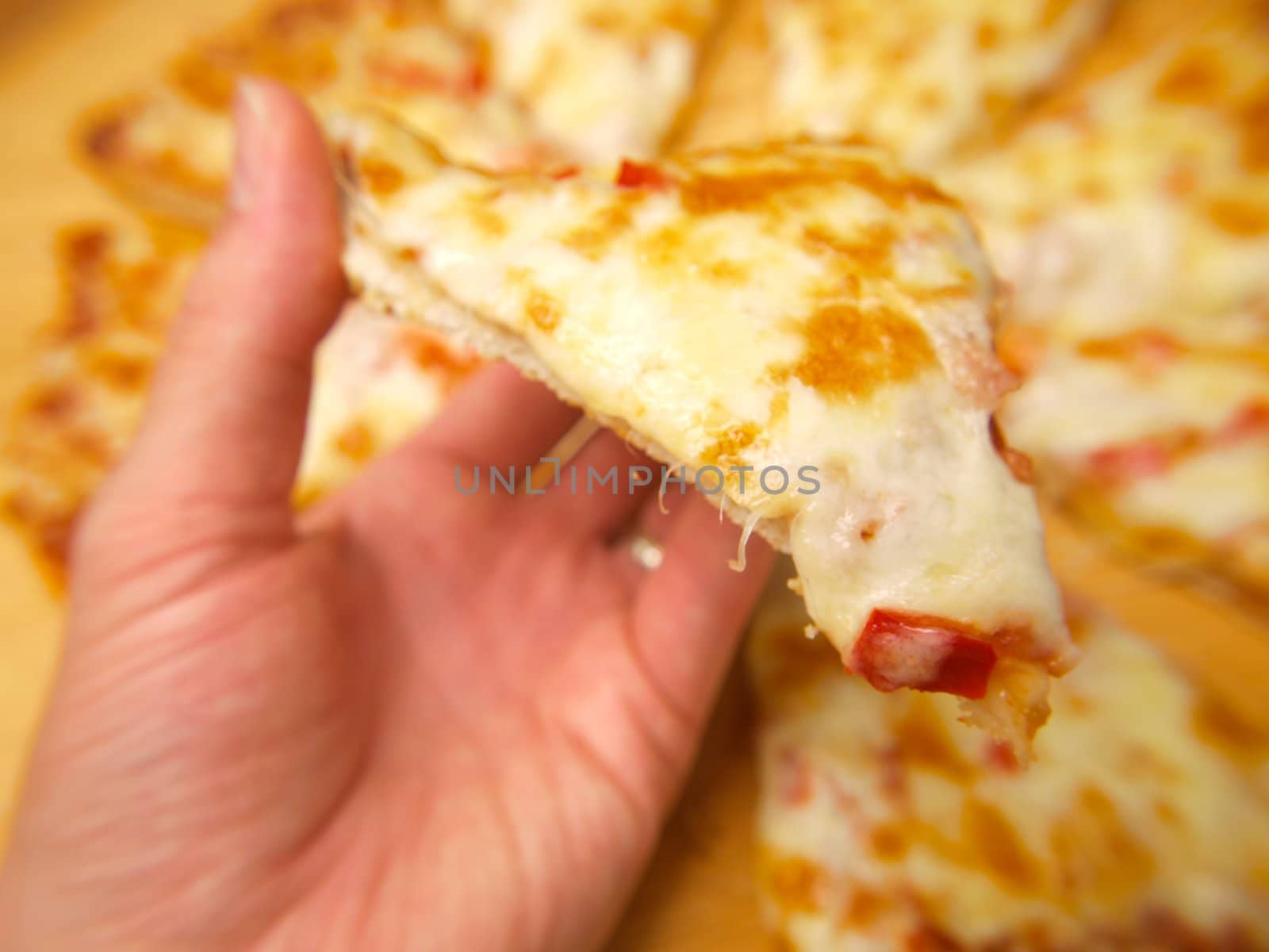 Slice of pizza, held up by a person by Arvebettum