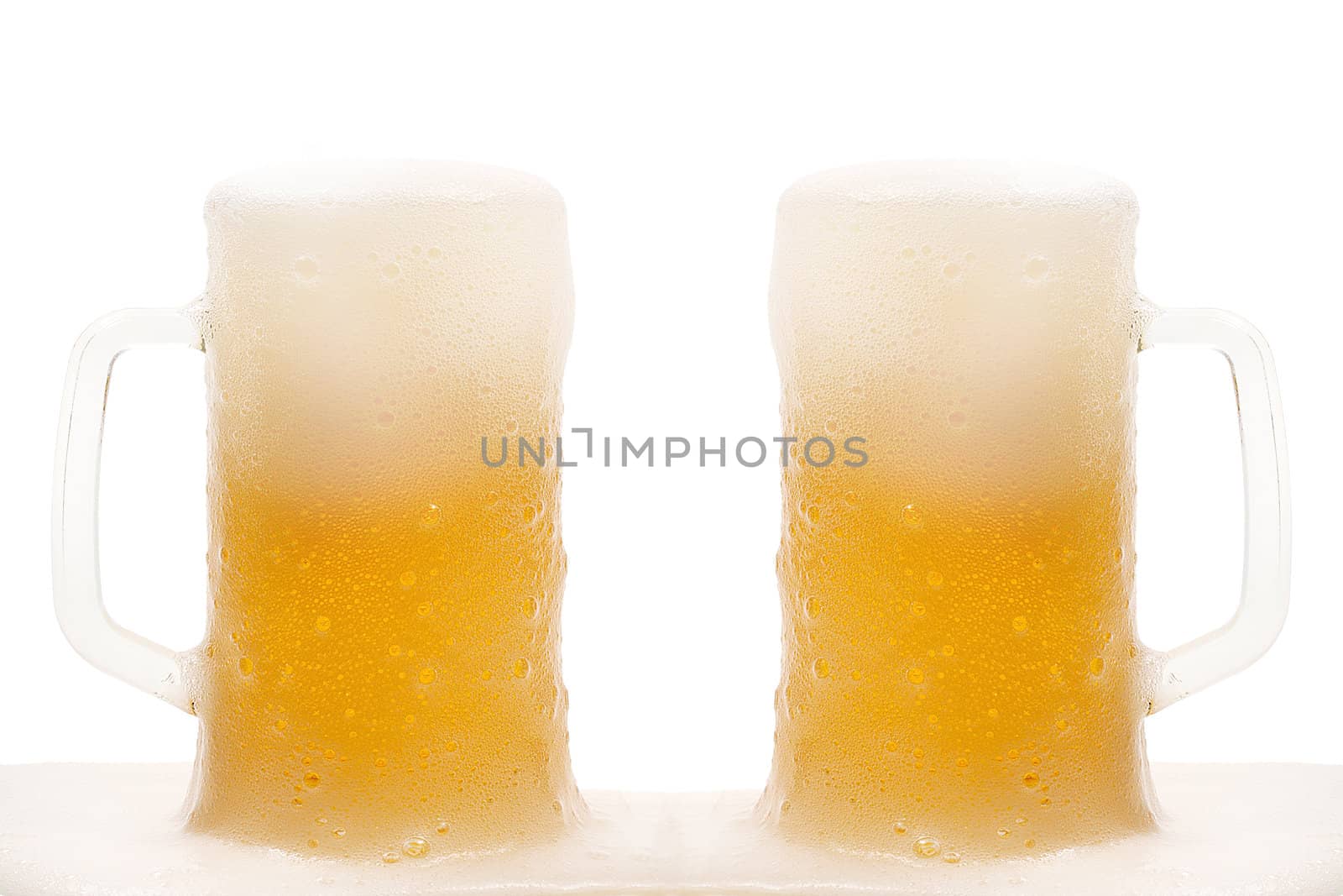 Two mug of beer with froth isolated on white background