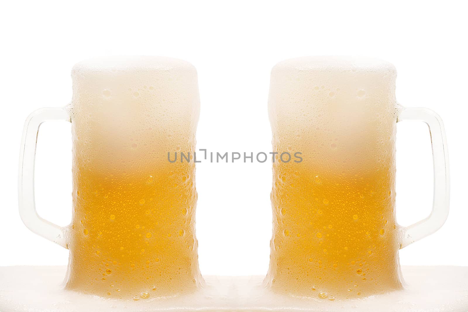 Two mug of beer with froth isolated on white background