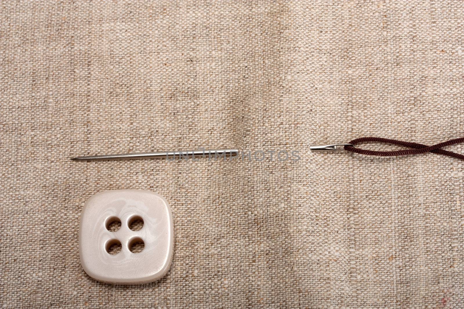 button needle and thread on background fabrics