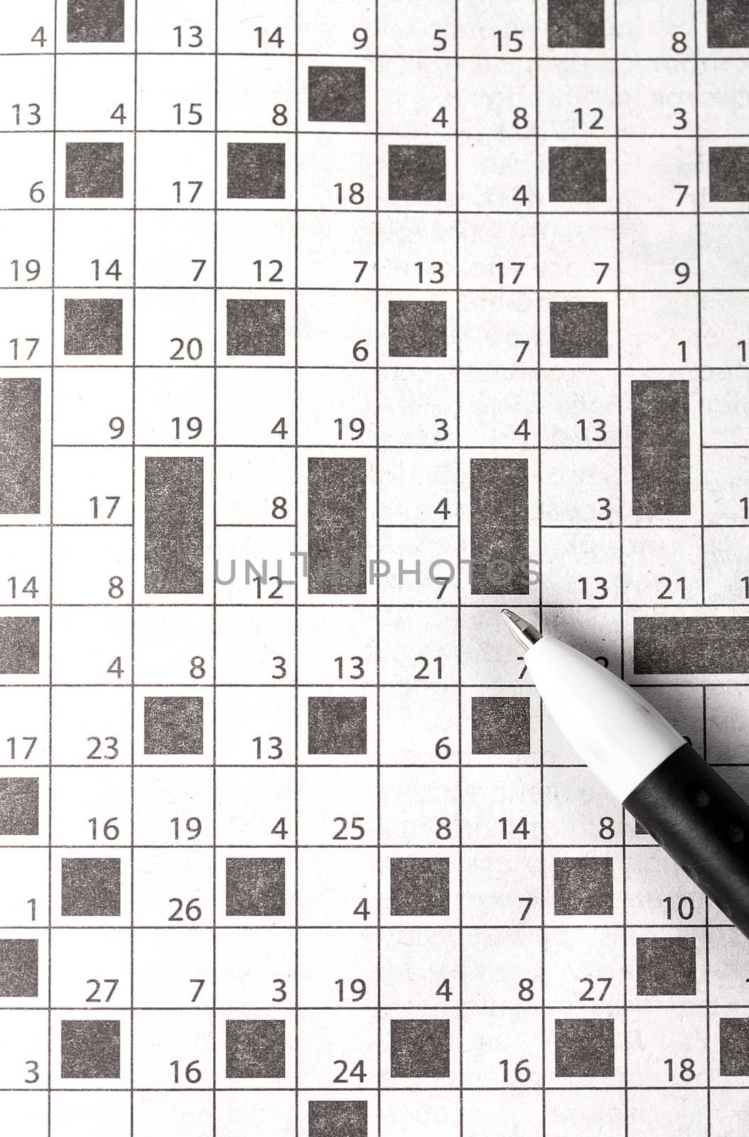 Crossword in newspaper concept and idea written pen