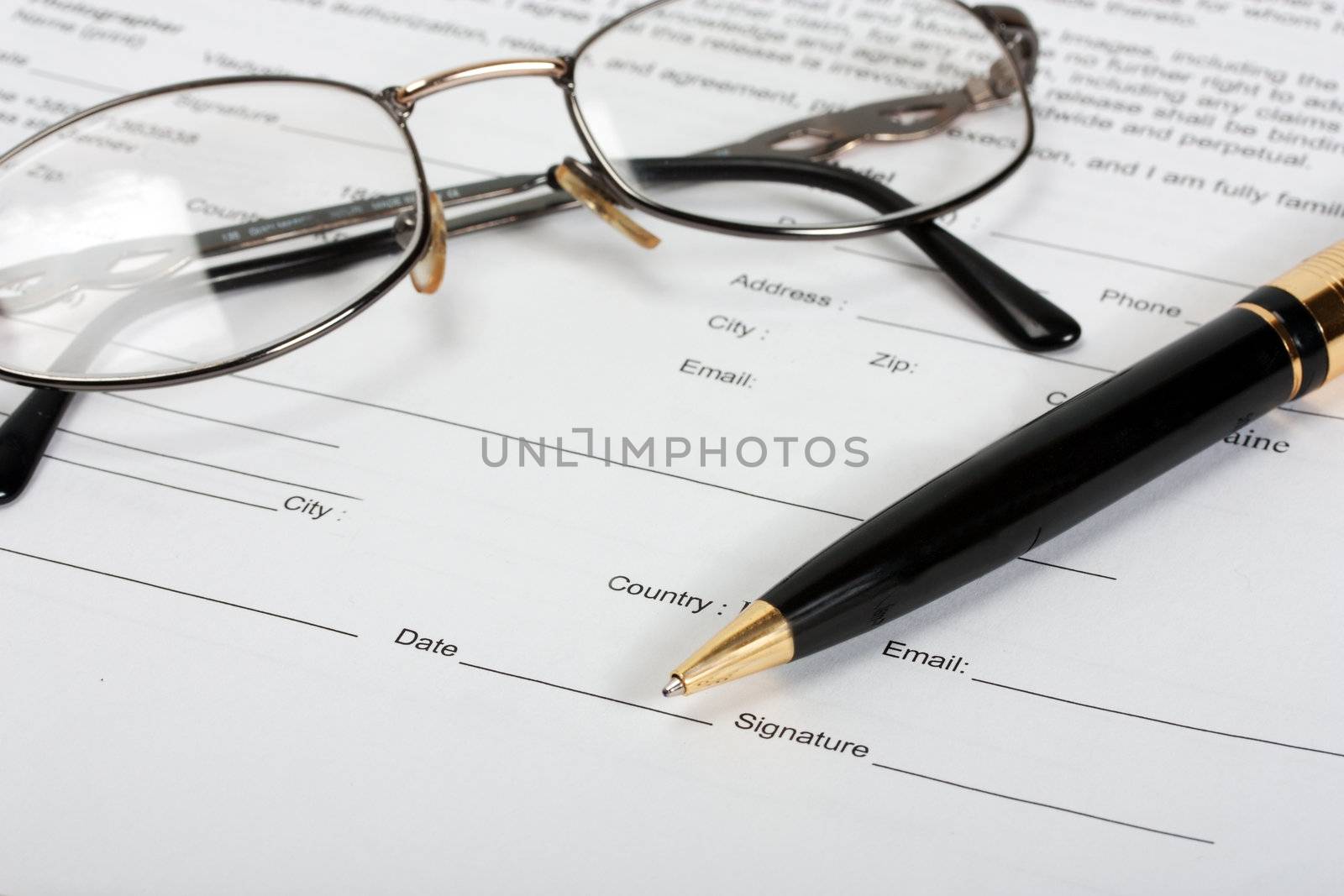 Signing contract-glasses and gold pen .