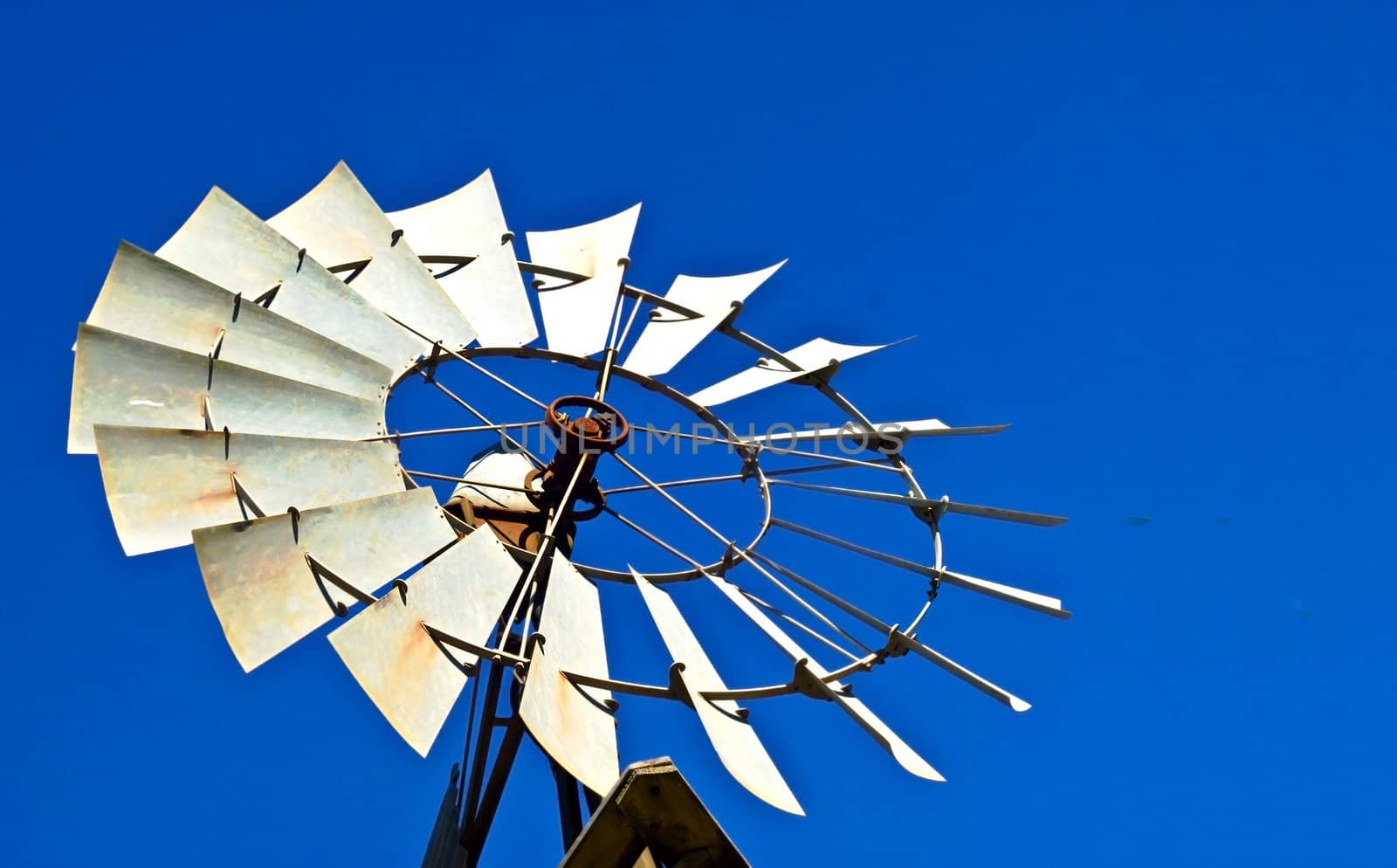 Rural Australian windmill against blue sky backdrop