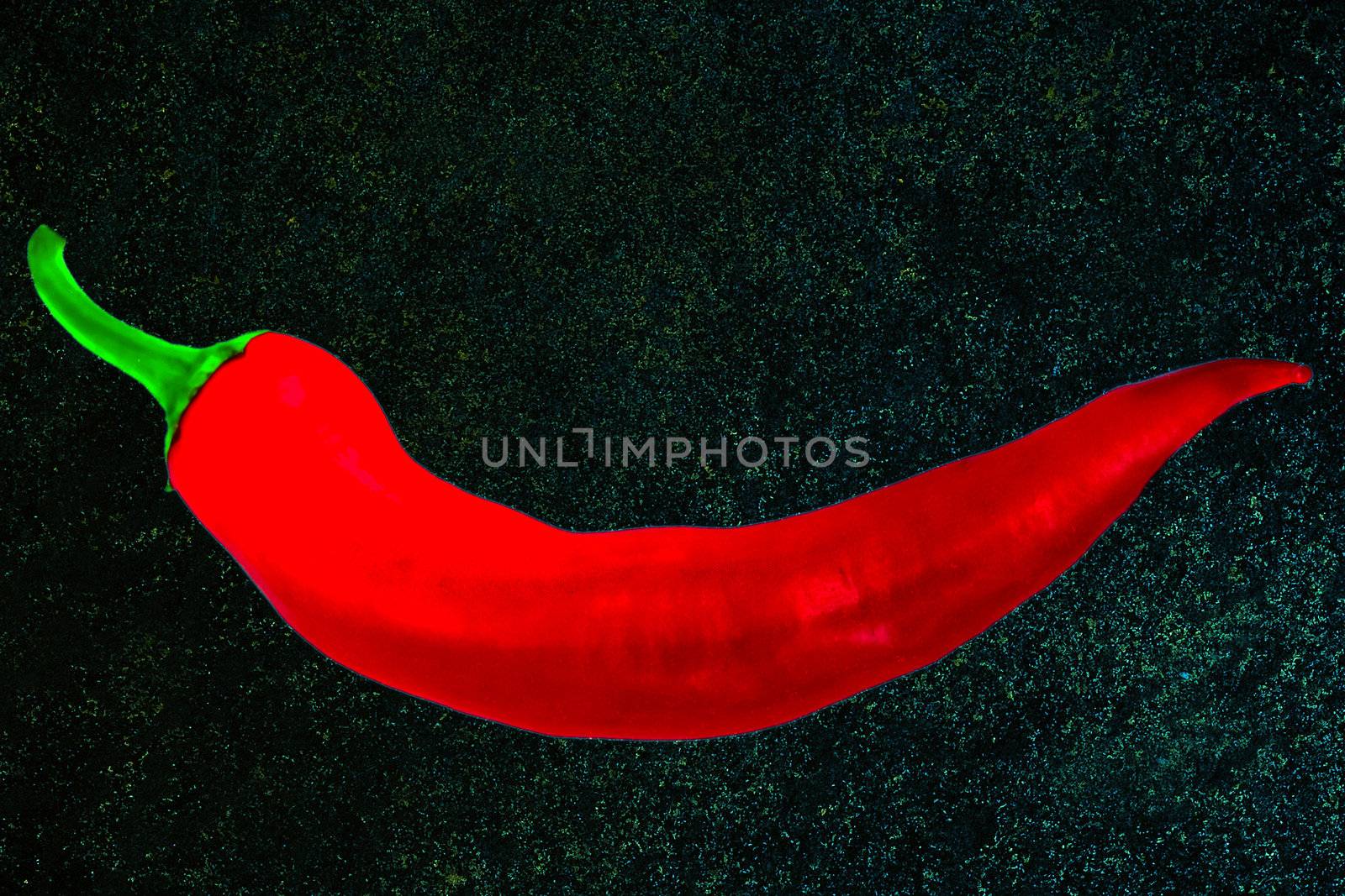 red pepper chile on black wall stone texture background