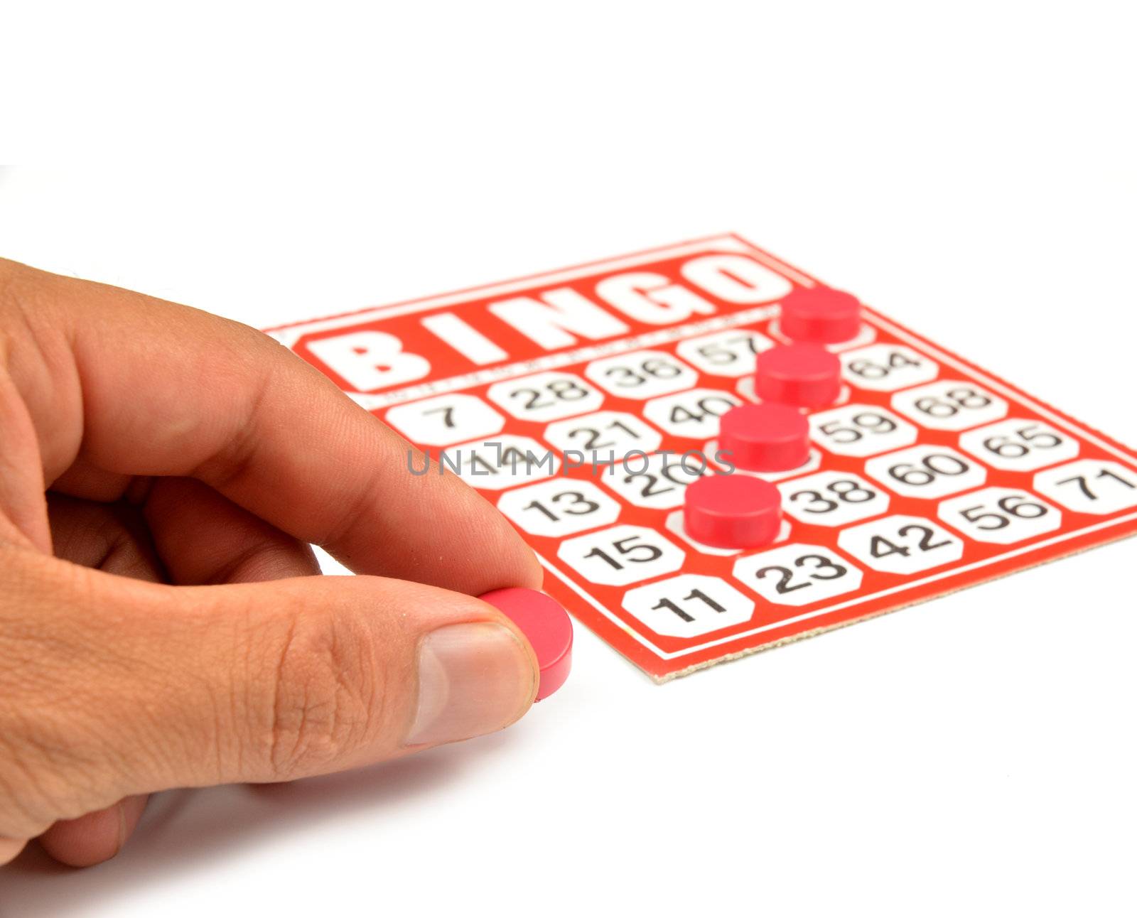 bingo card with hand hold winning chips 