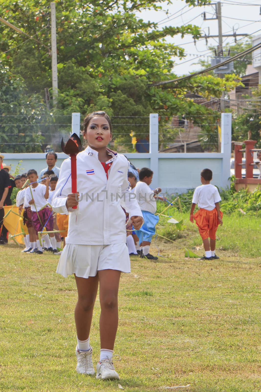 THAILAND - JULY 13: Miss Pirada Suwannarak tennis player champion carries the Torch during Dokbual game school parade on July 13, 2012 in Suratthanee, Thailand.