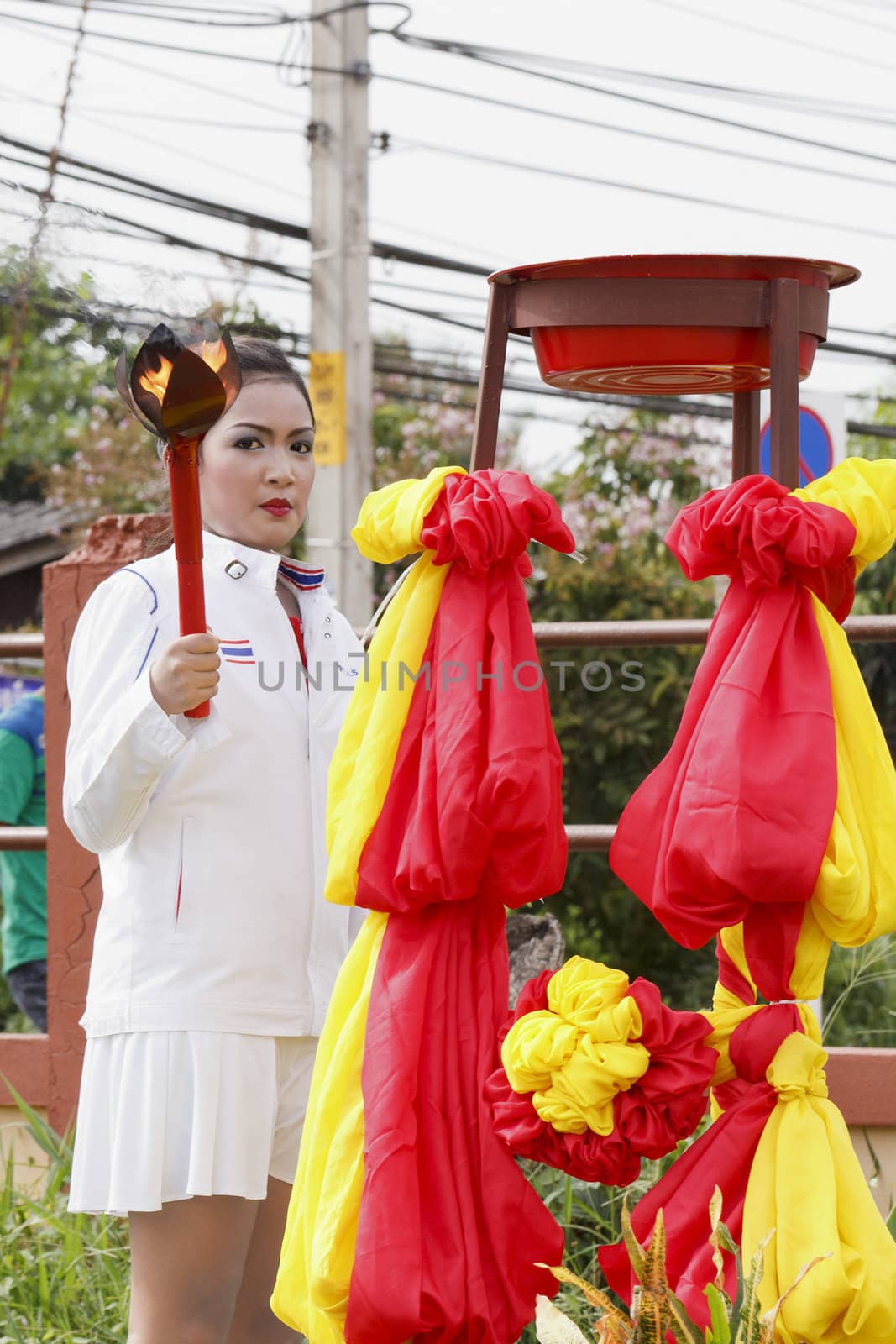 THAILAND - JULY 13: Miss Pirada Suwannarak tennis player champion shows the lighting of the Torch during Dokbual game school parade on July 13, 2012 in Suratthanee, Thailand.