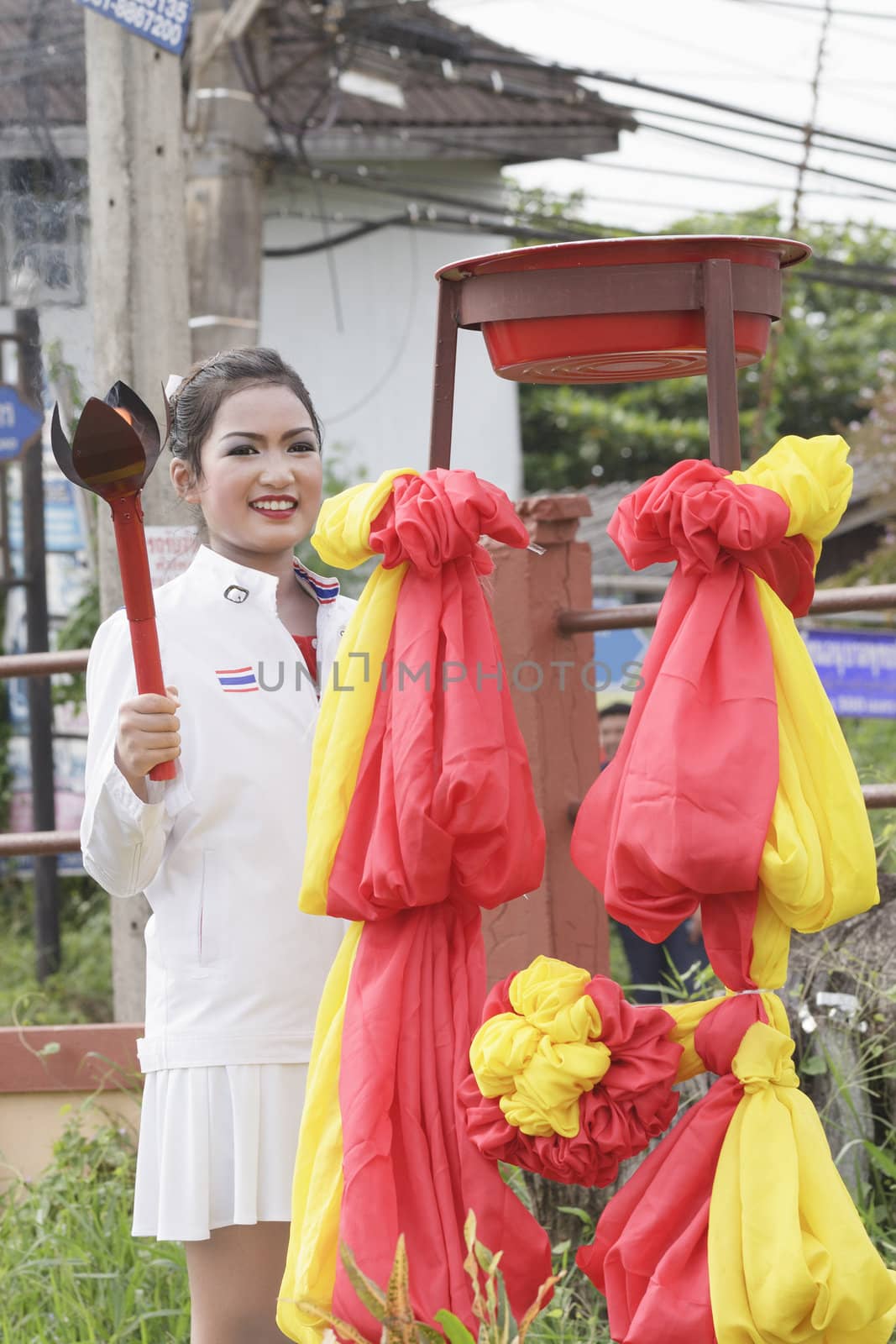 THAILAND - JULY 13: Miss Pirada Suwannarak tennis player champion shows the lighting of the Torch during Dokbual game school parade on July 13, 2012 in Suratthanee, Thailand.