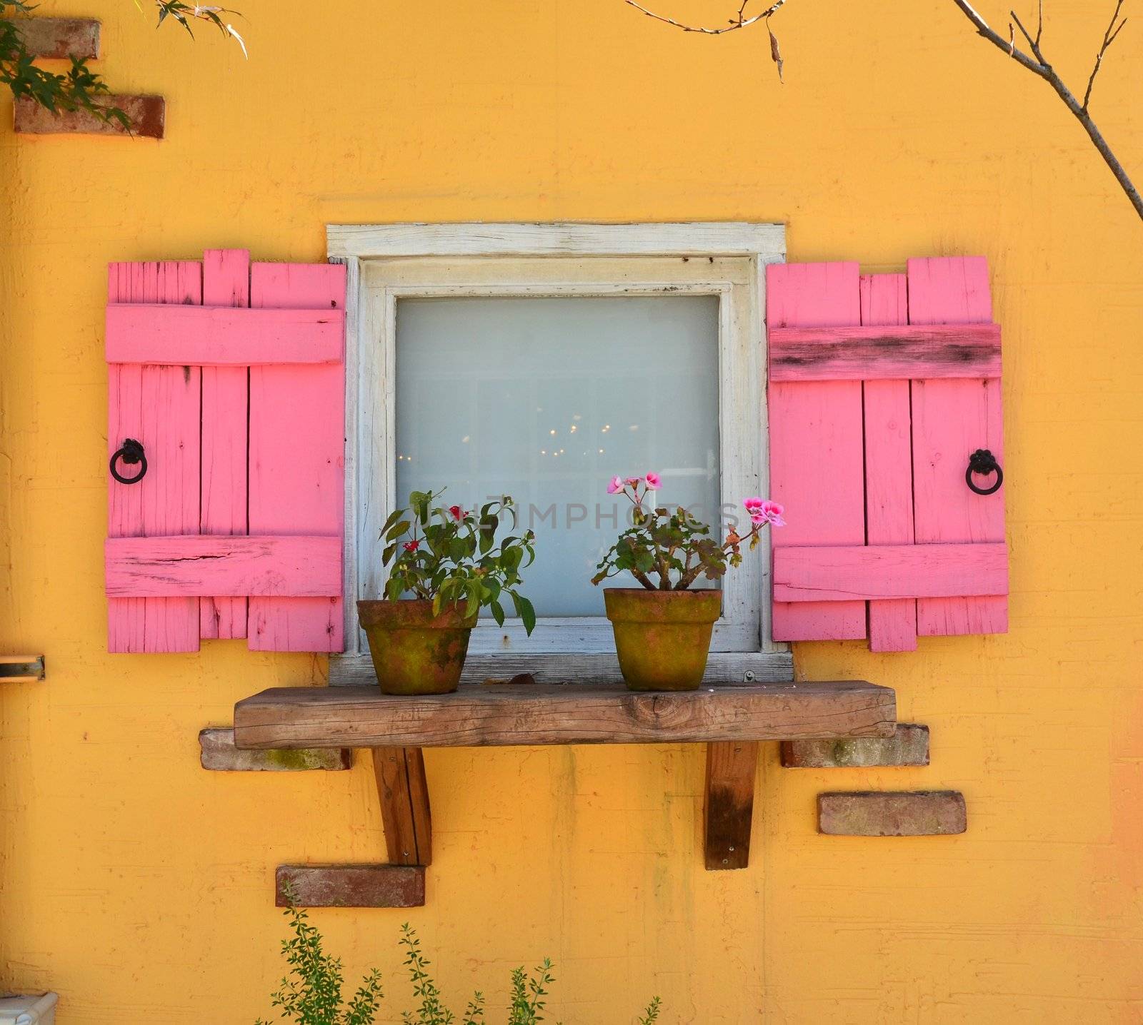 old open window and yellow wall