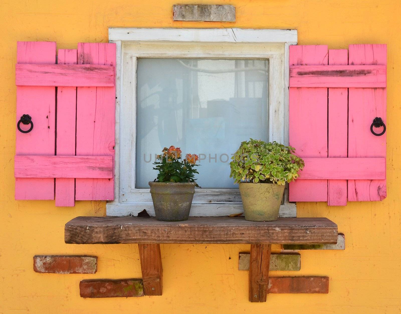 old open window and yellow wall