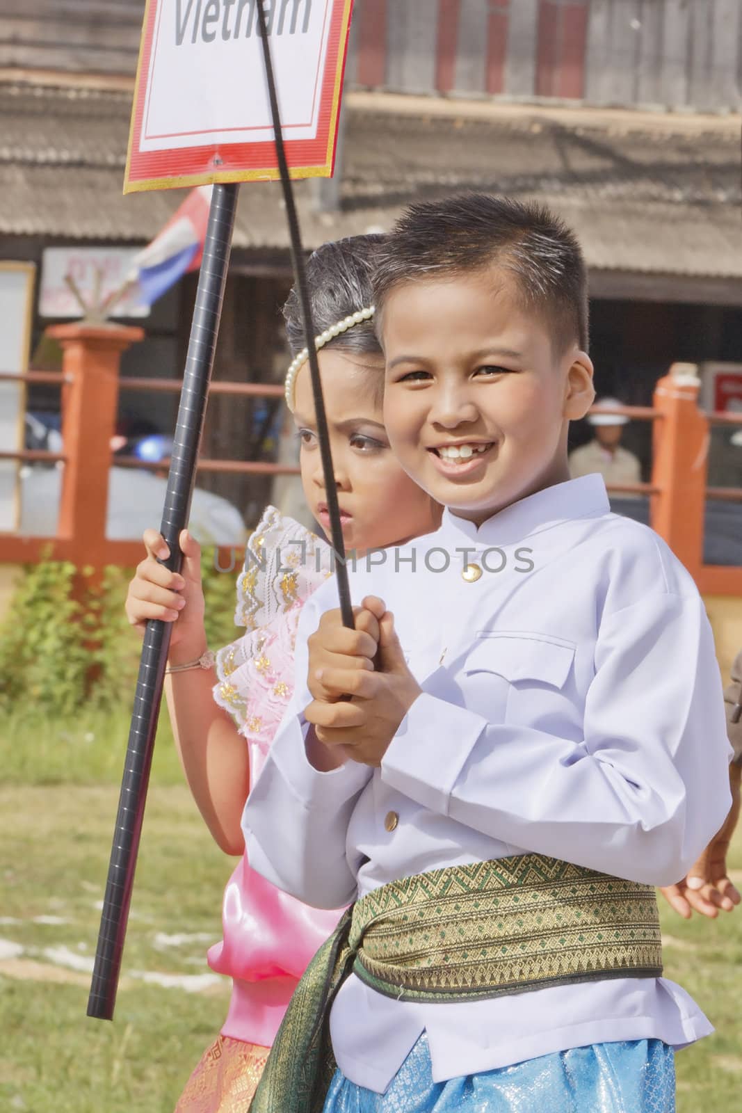 THAILAND - JULY 13: Thai students holding flag in Dokbual game school parade on July 13, 2012 in Suratthanee, Thailand.