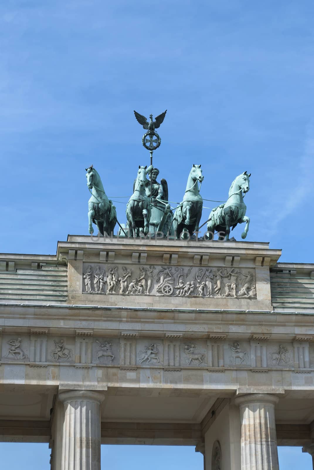 Brandenburg Gate Quadriga (German: Brandenburger Tor), former city gate, landmarks of Germany, on blue sky background