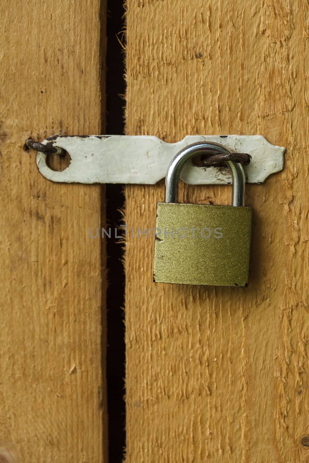 Metal lock on the wooden door closeup