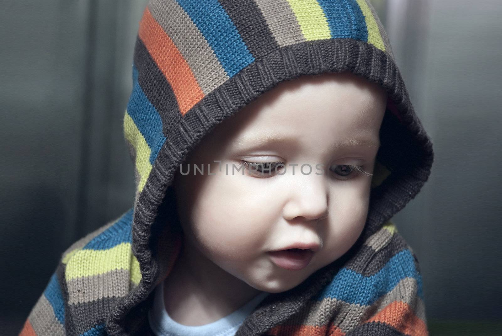 Closeup portrait of adorable child in hood.