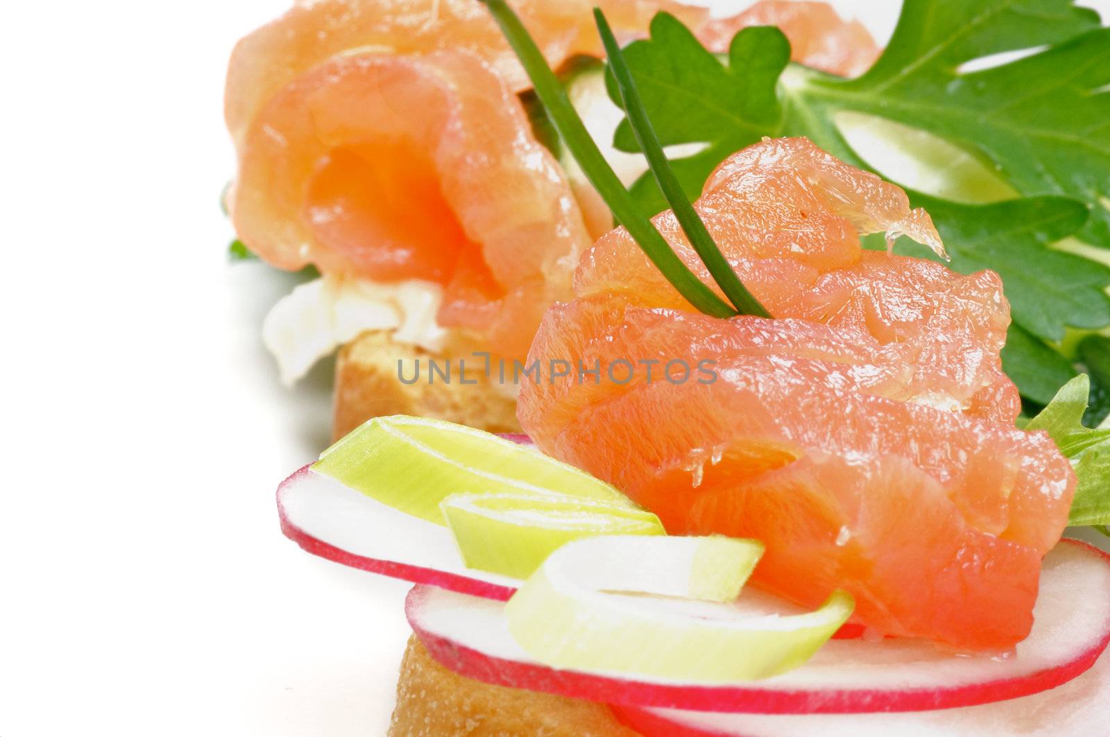 Snack of Smoked Salmon with Radish and Greens close up on white background