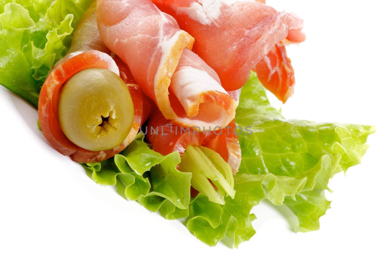 Snack of bacon with green olive and leaf lettuce isolated on white background