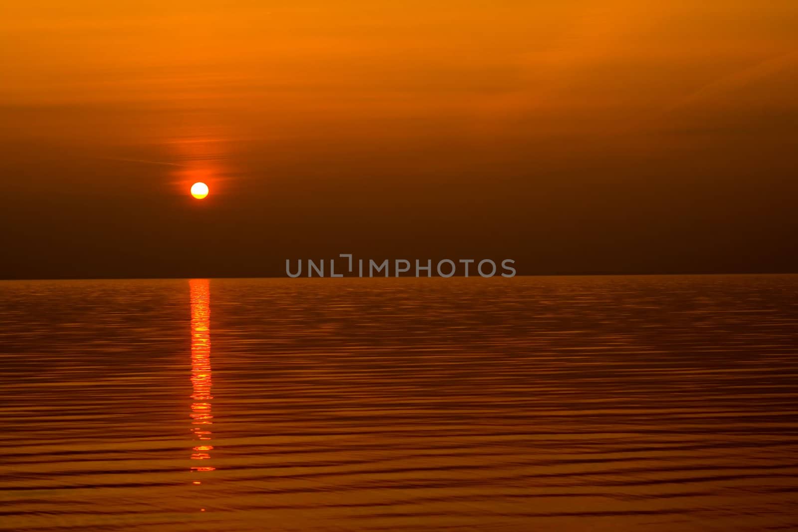 sundown scene with dark clouds and rays over sea. background, wallpaper.