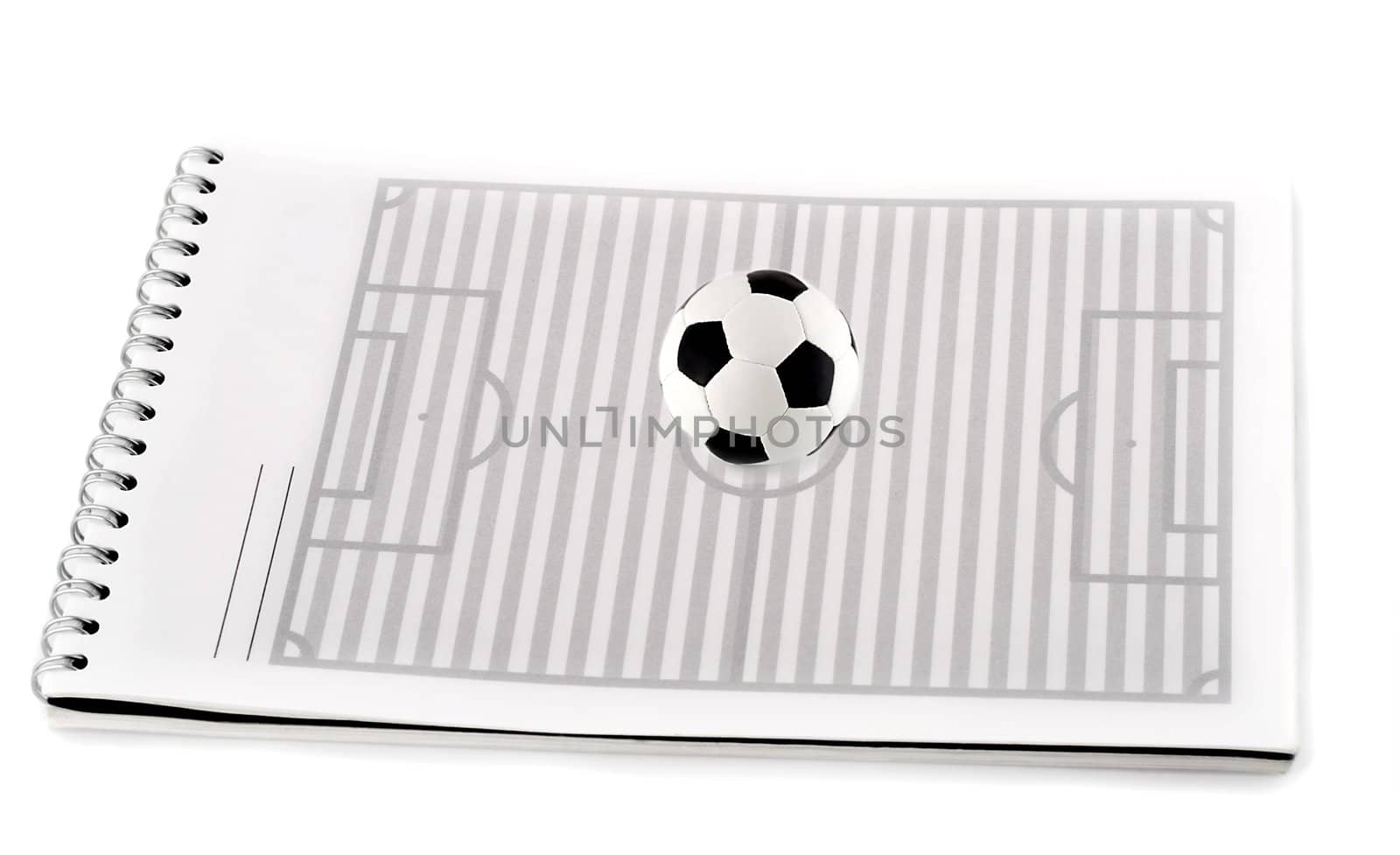 soccer field with ball in spiral note pad , isolated on white background