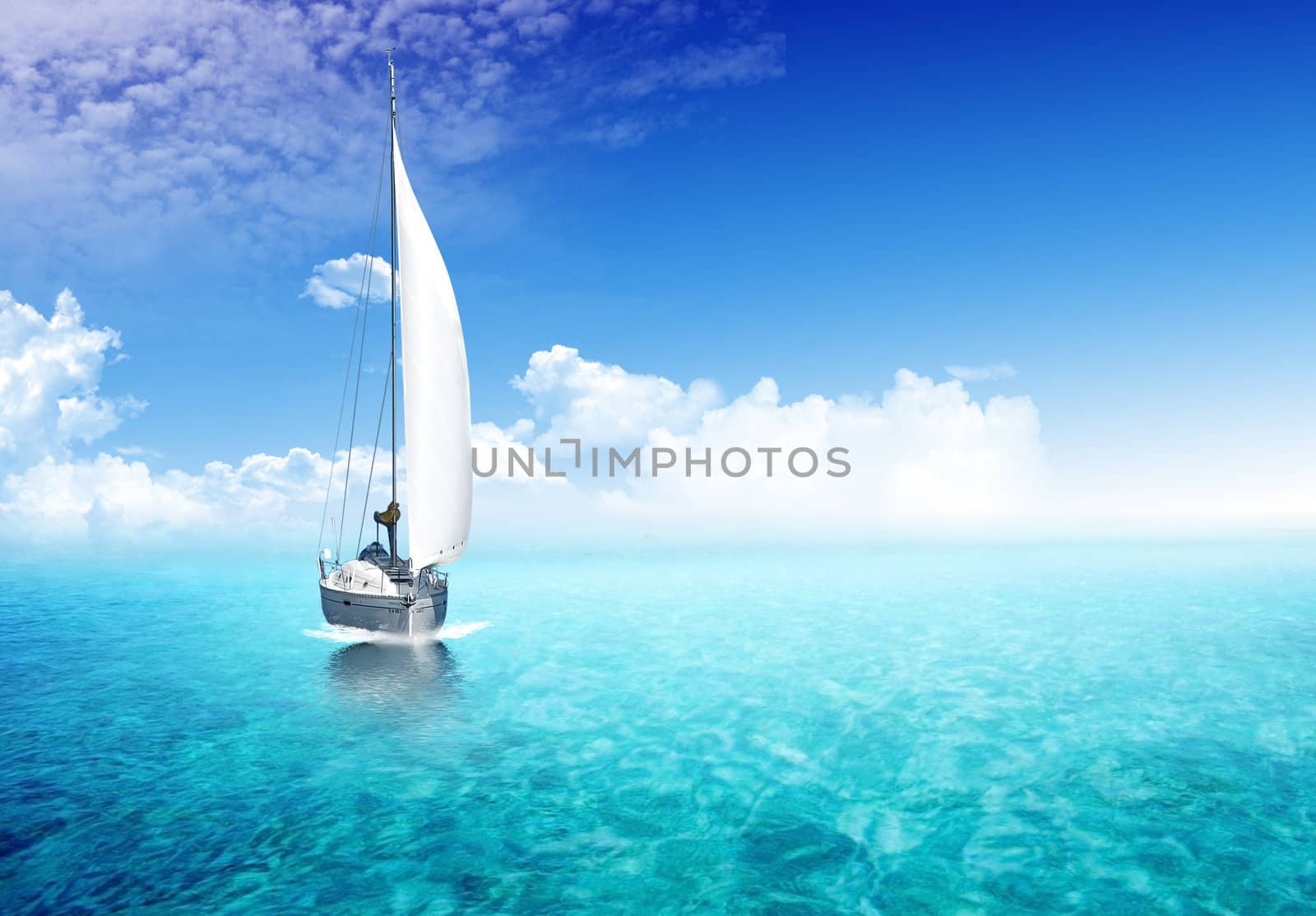 Sailing boat in the ocean with sunlight in the backgroiund