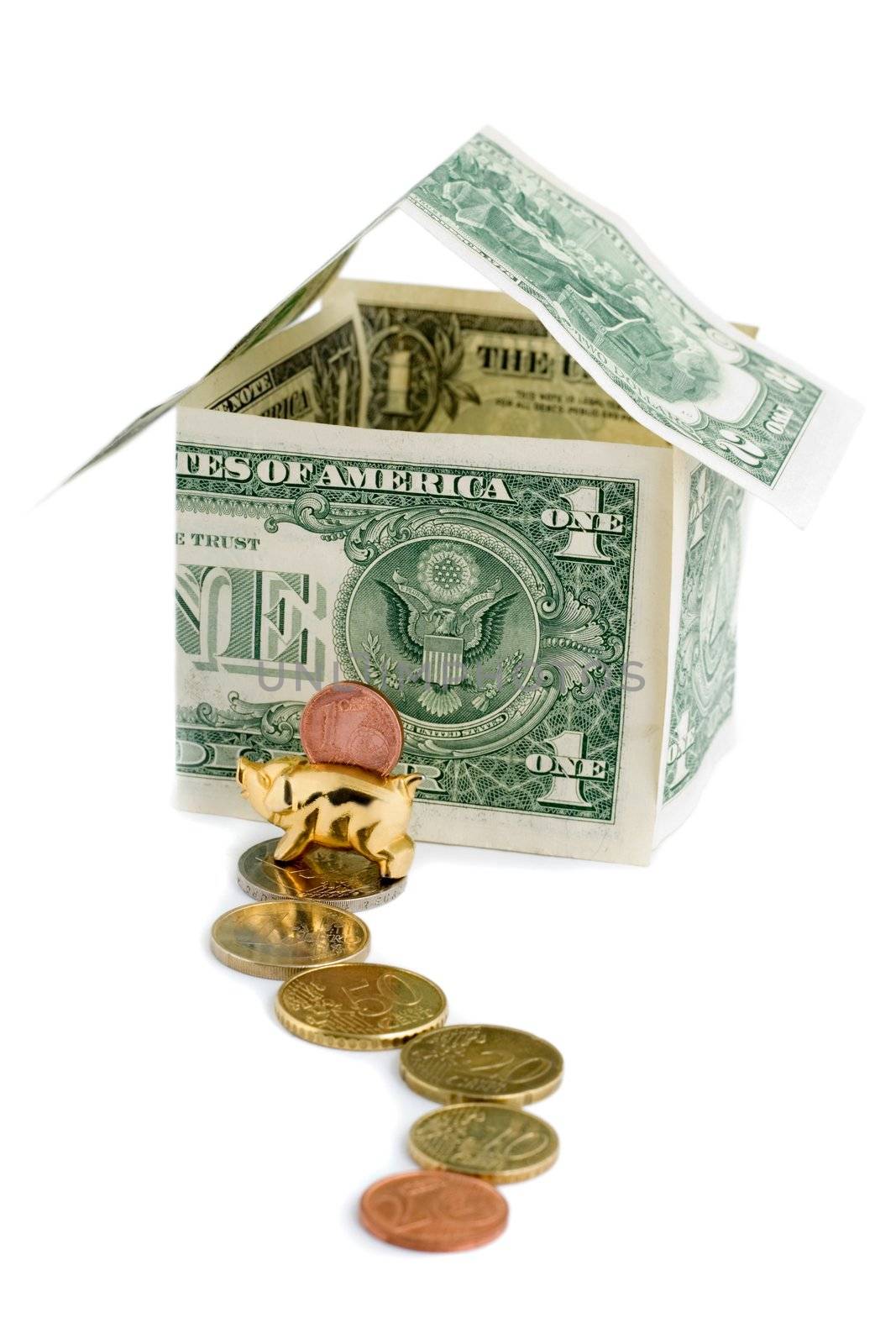 Money house from dollars coins and golden pig isolated on white background