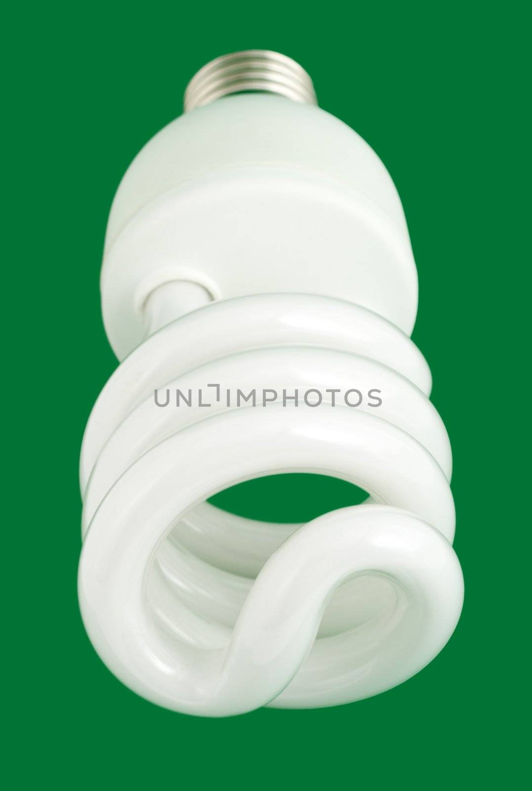 compact fluorescent light bulb close-up , isolated on green background
