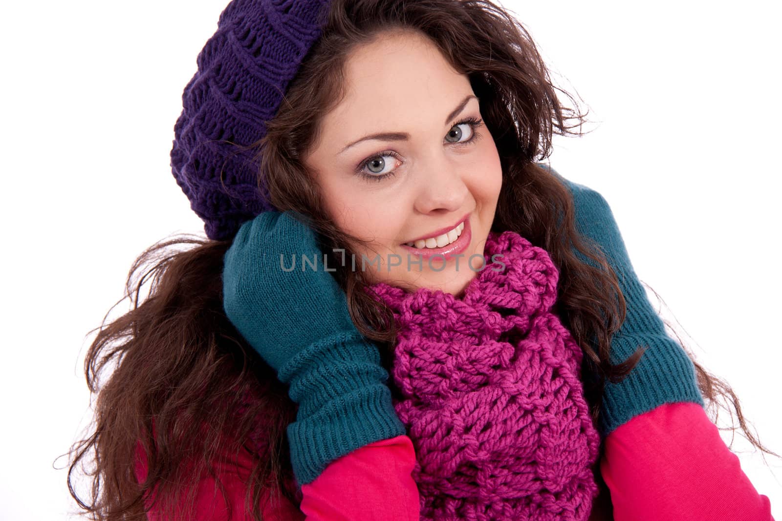 beautiful young smiling girl with hat and scarf in winter isolated on white background