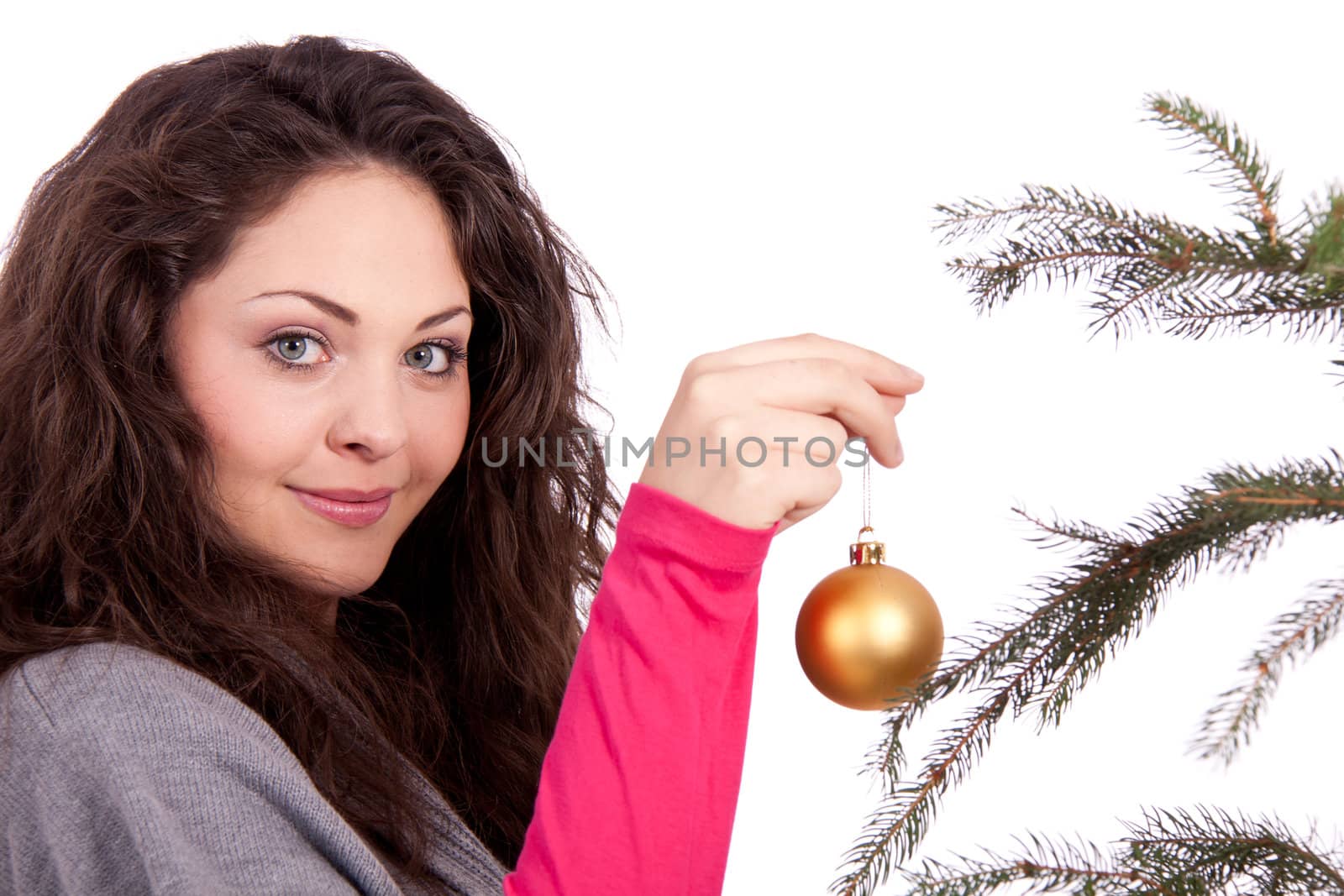 beautiful brunette woman is decorating a christmas tree isolated on white