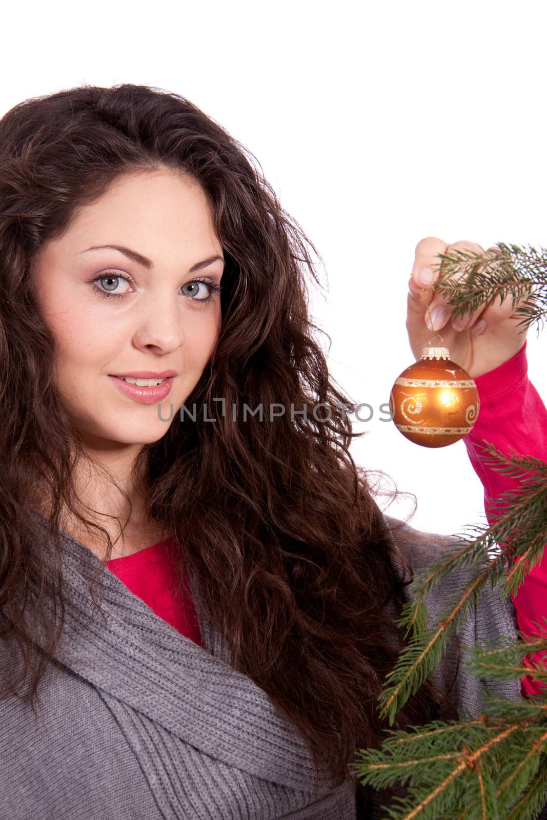beautiful brunette woman is decorating a christmas tree isolated on white