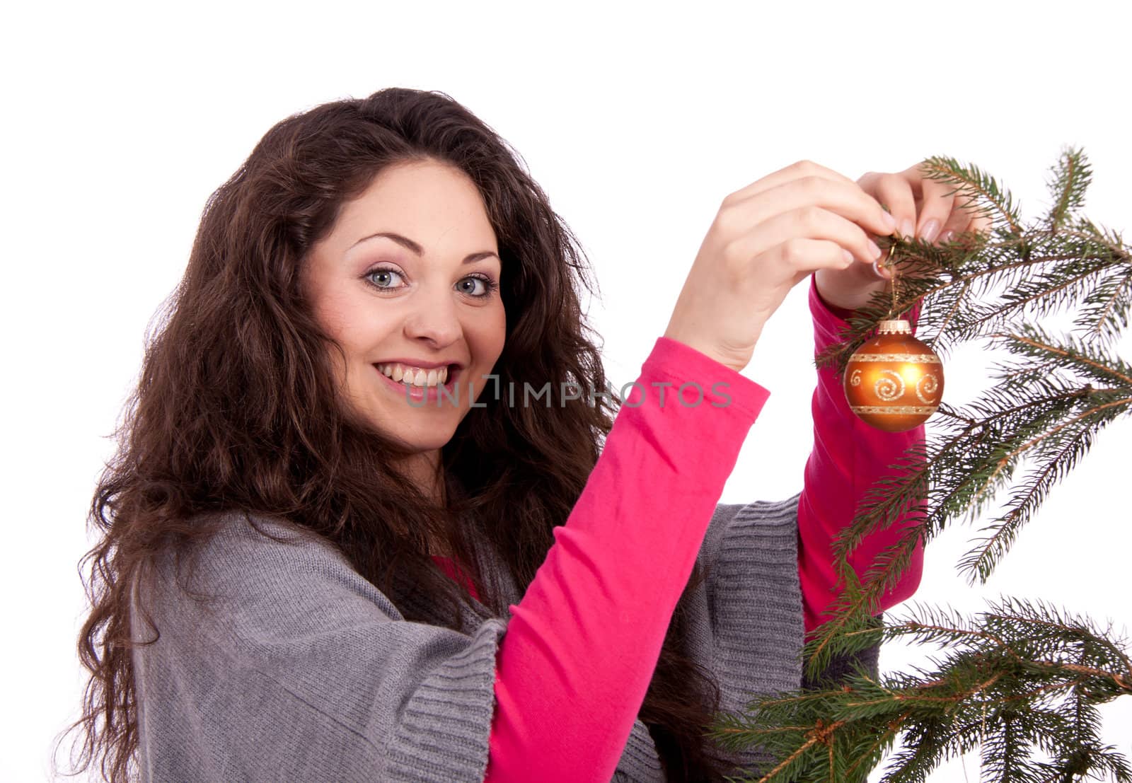 beautiful brunette woman is decorating a christmas tree isolated on white