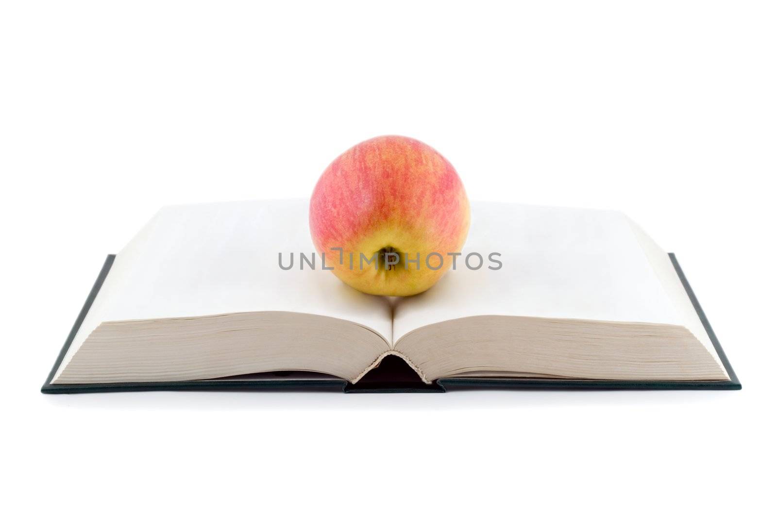 apple on opened book isolated on white background