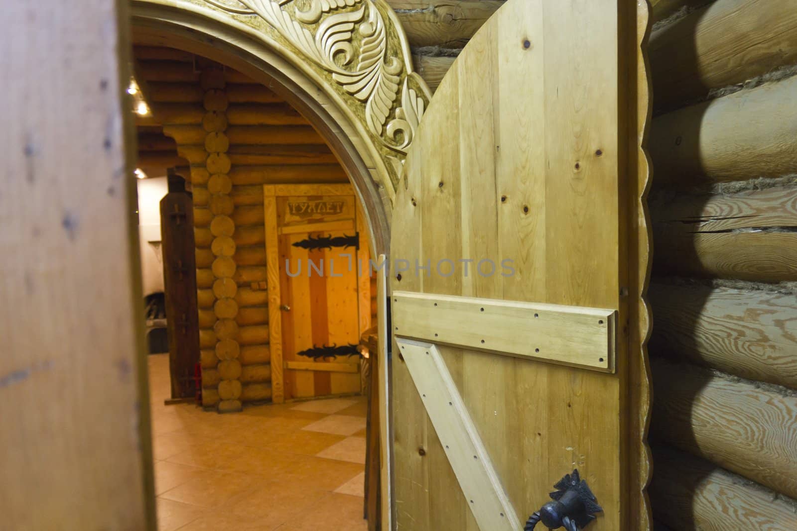 Wooden open door in Russian log hut